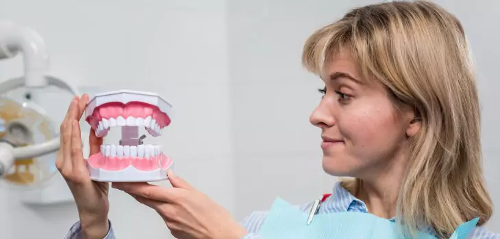woman with a set of teeth in her hands