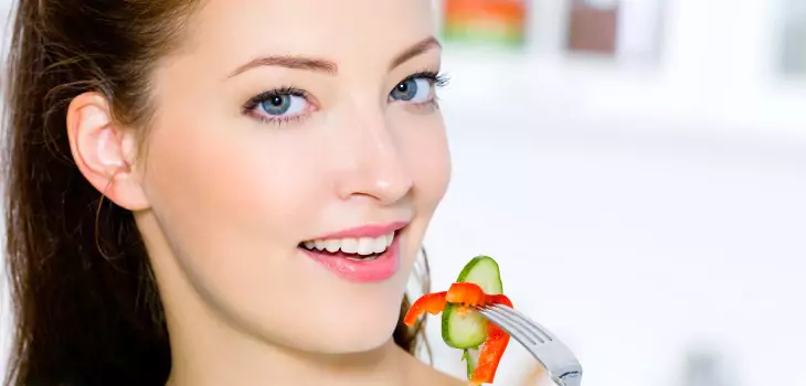 woman eating healthy food and smiling