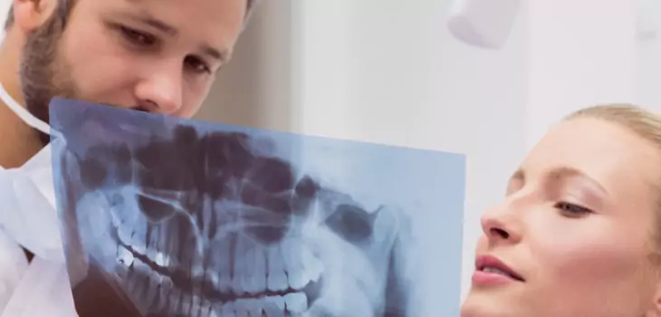 doctor and patient with xray of teeth