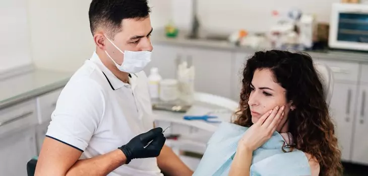 woman during a dental treatment with a dentist