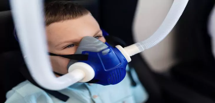 a kid is using laughing gas during dental visit