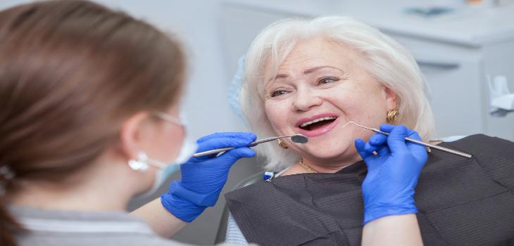 Close up of a cheerful elderly woman having dental examination by her dentist